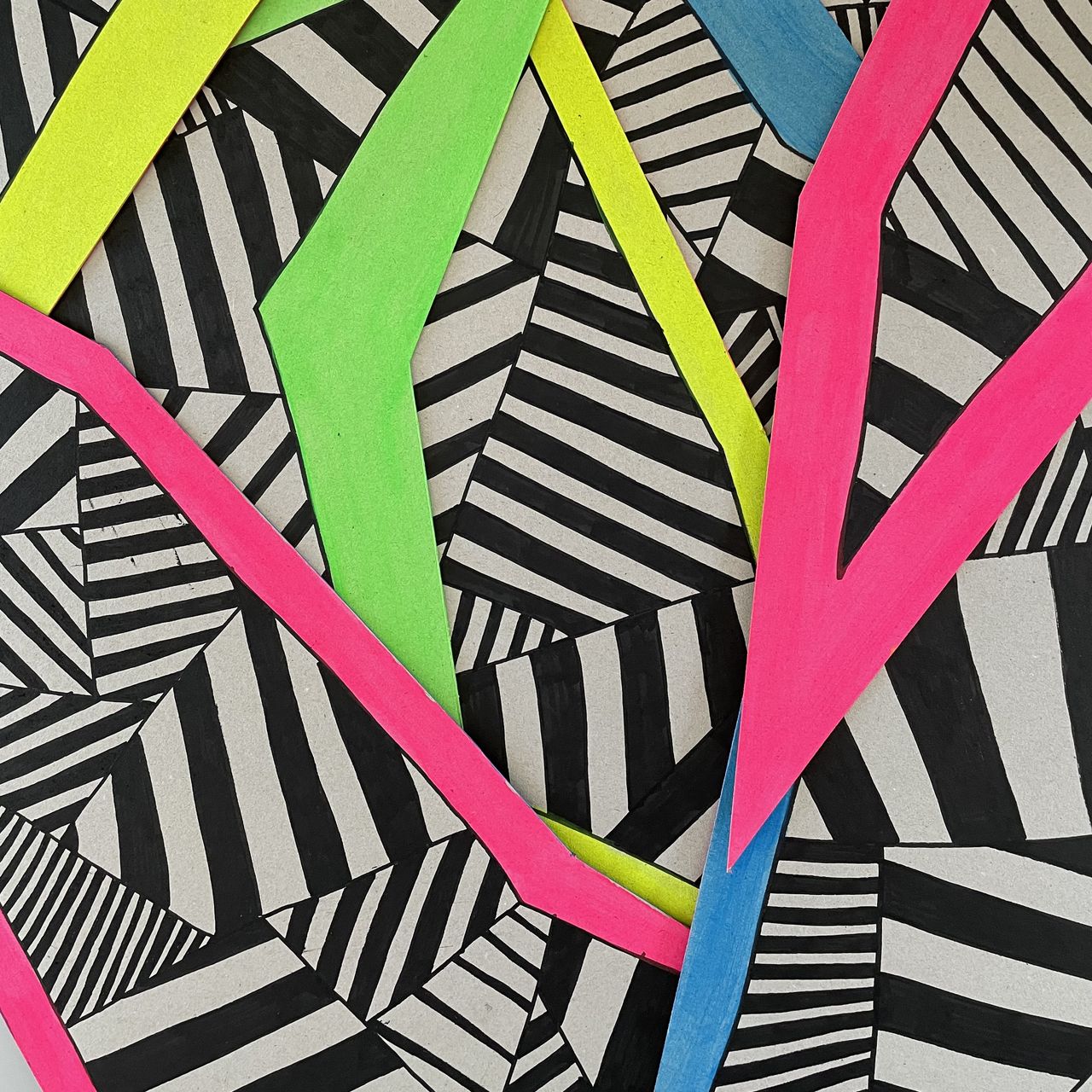 Pieces of cardboard painted with neon and black paint.